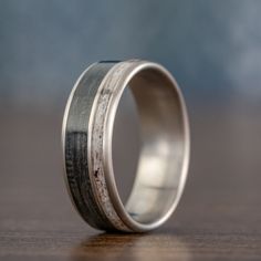 a wedding ring with silver and wood inlays