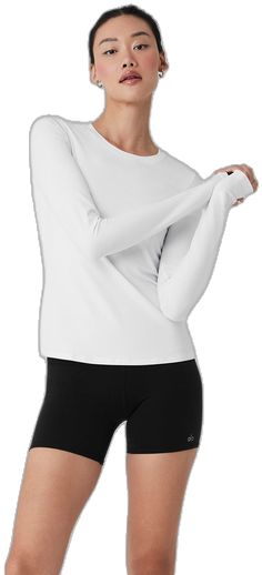 Alo Yoga Long Sleeve Top, White Long Sleeve Alo Yoga Top, Alo Yoga White Long Sleeve Tops, Alo Yoga White Stretch Top, White Stretch Alo Yoga Top, Alo Yoga Athleisure Solid Tops, Alo Yoga Solid Color Athleisure Tops, Alo Yoga Relaxed Fit Sports Top, Alo Yoga Long Sleeve Sporty Tops