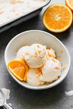 a bowl filled with ice cream and orange slices