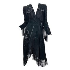 MUSUEM PIECE! Amazing and rare vintage 70s LOVE, MELODY black suede leather fringe rhinestone/studded wrap dress! Melody Sabatasso is a respected designer, known for her work with old Levi's. She dressed countless celebrities in the 1970s, including Cher, Elvis, Lauren Bacall just to name a few. She also made the famous Levi's bikini out of recycled Levi's. Melody custom made Emmylou Harris this exact dress in turquoise suede. So much hand detail went into the construction of this rare gem. Hundreds of rhinestones and studs throughout. Tie loops through the inner dress, and ties at the left side waist. In great condition Made in USA Approximately Size Small Measurements: 34-38 inch bust (adjustable because of wrap style) 26 inch waist 36 inch hips 44 inches from top back shoulder seam to h 1stdibs Fashion, Dress Western Style, Country Punk, 70s Love, Cowboy Dress, Jersey Evening Dress, 1950s Cocktail Dress, Black Corset Dress, Emmylou Harris