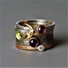 Designer statement stacking ring. Mixed metals of rose gold, yellow gold, white gold, oxidized silver, gold moon, diamond, and gemstones. What's not to love.  This is the most beautiful rustic gemstone stacking ring you will ever see, the ring stack includes five separate rings to wear alone or to stack together. One 9ct gold moon skinny silver blossom ring One Amethyst Wide blossom ring with gold setting One skinny 9ct yellow gold ring and peridot gemstone set in silver One skinny Pink Tourmali Wizard Jewelry, Gemstone Stacking Ring, Gold Amethyst Ring, Statement Rings Diamond, Diamond Stacking Rings, Rose Gold Diamond Ring, Gold Heart Necklace, Gold Moon, White Gold Diamond Rings