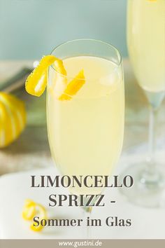 two glasses filled with lemonade sitting on top of a table