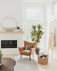 a living room filled with furniture and a fire place next to a large mirror on the wall