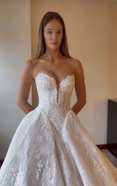 a woman in a wedding dress posing for the camera