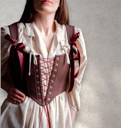 Reversible linen corset with front lacing, Custom corset top, brown & red corset, Renaissance faire costume, Overbust victorian stays Transform your wardrobe with this stunning reversible corset ♡ Adorned in burgundy linen and classic brown linen on the other, this versatile piece offers double the style in one chic design. Featuring front lacing this corset ensures a perfect fit while adding an elegant touch to any ensemble.  ♡ Features♡ An accessory that evokes feelings of femininity, slendern Historical Underbust Corset For Costume, Gothic Brown Corset Dress For Costume Party, Fitted Brown Corset For Cosplay, Brown Fitted Corset For Cosplay, Brown Gothic Corset Dress For Costume Party, Brown Corset For Cosplay, Medieval Style Underbust Corset Belt With Boned Bodice, Medieval Underbust Corset Dress With Corset Back, Medieval Underbust Corset Dress