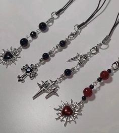 ✨ Handmade ✨ Gothic Phone Charms * Black Cross Charm Length: (from beads to charm) 2.5 in. * Red Heart Charm Length: (from beads to charm) 2.5 in. * Black Heart Charm Length: (from beads to charm) 2.5in *Stars Charm Length: (from beads to charm) 2.5in * Lengths may slightly vary due to them being handmade * * Charms may tarnish * *Keep dry and away from chemicals * Gothic Keychain, Beaded Phone Charms, Dark Jewelry, Beaded Bookmarks, Diy Jewelry Projects, Black Cross, Handmade Charms