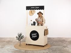 a woman standing behind a counter selling items