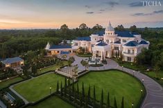 an aerial view of a large white mansion