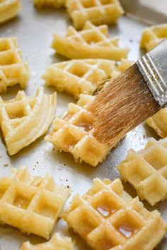 the waffles are being brushed with a brush