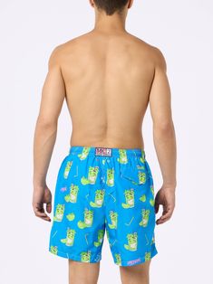 Man Lighting mid-length swim shorts are designed with a lightweight fabric that dries quickly, earning their name Lighting. The elasticized waistband and drawstring closure with branded terminals ensure a comfortable fit, while the branded eyelets are strategically placed to drain water and prevent the shorts from ballooning. Featuring side pockets with French seams and a back patch pocket with a magnetic closure, these swim shorts are both practical and stylish. Additionally, there's a small internal coin pocket for added convenience. The all-over print adds a touch of flair to this versatile swimwear option. The shorts can be neatly folded and stored in the rear pocket when not in use. Crafted from 100% recycled polyester, these shorts reflect our commitment to sustainability. Man Lighti Playful Pool Bottoms With Built-in Shorts, Playful Bottoms With Elastic Waistband For Pool, Playful Swim Trunks With Elastic Waistband For Poolside, Playful Swim Trunks With Elastic Waistband, Playful Short Swim Trunks With Elastic Waistband, Playful Short Swimwear For Poolside, Playful Short Swim Trunks For Swimming, Playful Short Swim Bottoms, Playful Short Length Bottoms For Swimming