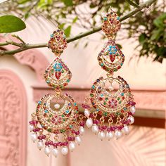 Navrattan Chandbali earrings. Weight - 25.5 GMs Height - 9 cm Width - 3.5 cm All of Rudradhan's Gold Plated Jewellery is made using 925 Silver, real freshwater pearls and high quality ruby, emerald and sapphire beads. The default choice for studded stones used is synthetic that closely resemble original gemstones. Long Earrings Indian, 22k Gold Jewelry Necklaces, Baby Jewelry Gold, Hyderabadi Jewelry, Jadau Jewellery, Gold Jhumka, Gold Jhumka Earrings, Artificial Jewelry, Sapphire Beads