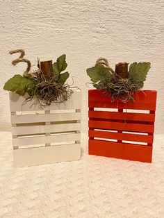 two wooden crates with plants in them sitting on a white counter top next to each other