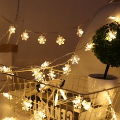 a shopping cart with snowflakes hanging from it's side and a potted plant in the background