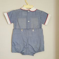 - This adorable outfit by C.I. Castro and Co. is perfect for any occasion. It is 2 pieces and navy blue gingham with a white collar piped in red. Across the chest is a retro ribbon with clowns and blocks. It buttons down back and snaps between legs. Sizes are: 9 months (21 available) 12 months (3) Cute Fitted Gingham Sets, Fitted Gingham Cotton Sets, Navy Cotton Playtime Sets, Cotton Navy Sets For Playtime, Preppy Fitted Cotton Sets, Gingham Cotton Short Sleeve Set, Gingham Cotton Set With Short Sleeve, Sailor Shirt, Baby Boy Clothing Sets