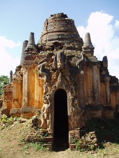 an old stone structure with many spires in the middle and one door at the end