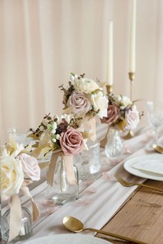 the table is set with flowers and candles