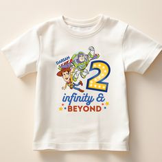 a white t - shirt with the number two and toy story characters printed on it