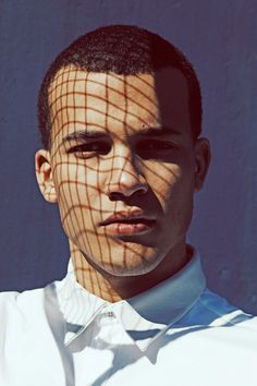 a man is wearing a white shirt and has his hair pulled back with a net on it