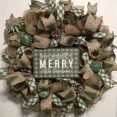 a christmas wreath hanging on the front door with words above it that says have yourself a merry little christmas