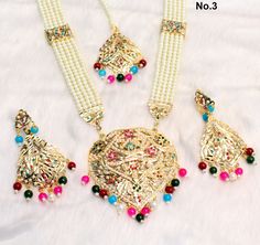 Jadau navrattan Rani Haar necklace Set embellished with pearls. Necklace length: 13 inches (including pendant) Earrings length: 2.9 inches (with drops) ; Width: 1.3 inches Multicolor Kundan Necklace For Festive Occasions, Multicolor Kundan Necklace For Eid, Multicolor Kundan Necklace For Festive Eid Occasions, Multicolor Bridal Necklace With Latkans For Puja, Festive Multicolor Kundan Necklace For Eid, Multicolor Bollywood Kundan Necklace For Eid, Traditional Multicolor Long Bridal Necklace, Multicolor Chandbali Necklaces For Eid, Multicolor Bridal Necklace For Puja And Festive Occasions