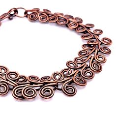 Twenty-eight Egyptian coils make up the links in this copper bracelet. Finished in a beautiful golden brown patina. length: 6 3/4"width: 1/2"closure: hook and eyemetal: oxidized copper Entirely handmade in Lincoln, Nebraska Adjustable Bronze Copper Bracelets, Adjustable Spiral Copper Bracelet, Adjustable Spiral Copper Bracelets, Adjustable Copper Spiral Bracelet, Handmade Spiral Copper Bracelets, Handmade Spiral Copper Bracelet, Bronze Copper Wire Bracelet, Bronze Metal Bracelet With Patina, Hand Forged Bronze Metal Bracelets