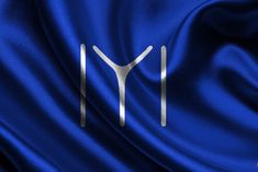 the letter y is shown in white on a blue satin background with silver letters and lines