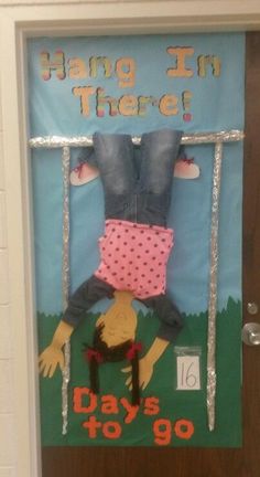 a door decorated with an image of a person hanging from a chair and text reading hang in there days to go