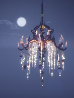 a large chandelier with many lights hanging from it's sides in front of a full moon