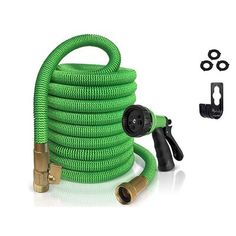 a green garden hose with nozzles on it and other accessories around the hose