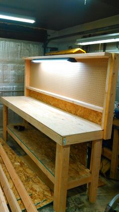 an unfinished workbench is being built in a garage