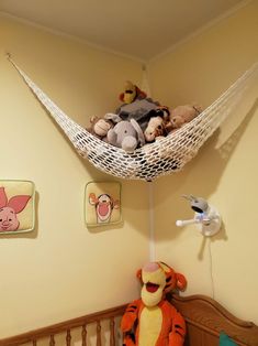 a stuffed animal hammock hanging from the ceiling in a child's room