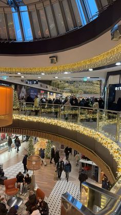 an overhead view of people walking around in a shopping mall with christmas decorations on the ceiling