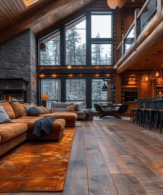 a living room filled with lots of furniture next to a large wooden flooring area