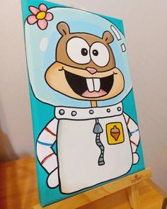 a painting of a cartoon character on a wooden easel with a flower in it