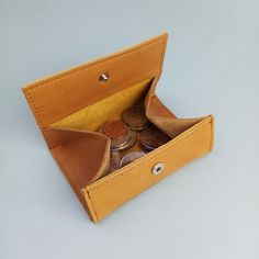 an open wallet with coins in it