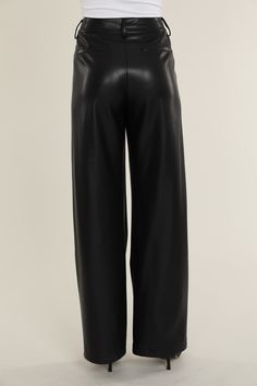 Elevate your professional outfits (or even just your everyday looks) with an edgy wardrobe staple like our Faux Leather Wide Leg Trouser Pants. Tailored to perfection, these wide legged trousers offer a relaxed yet polished vibe, ideal for curating a smart casual look. The sleek faux leather material lends a modern edge, while the wide leg cut ensures a comfortable, airy feel. Pair these with a crisp blouse or a casual tee to create versatile looks that transition effortlessly from office hours Chic Wide-leg Leather Pants For Workwear, Sleek Wide-leg Leather Pants For Fall, Sleek Wide Leg Leather Pants For Spring, Faux Leather Wide Leg Pants For Work, Wide Leg Faux Leather Work Pants, Chic High Waist Faux Leather Wide Leg Pants, Elegant Wide Leg Faux Leather Pants, Elegant Faux Leather Wide Leg Pants, Elegant Faux Leather Wide-leg Pants