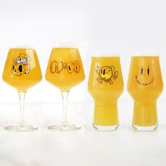 four glasses filled with different types of beer