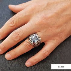 a man's hand with a ring on it