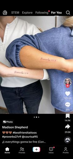 two people with tattoos on their arms and one is holding the other's arm