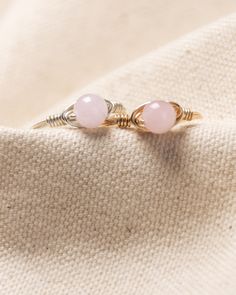 Our minimalist, most layered, wire-wrapped rings are going to be your newest obsession! Mix and match to create your own style with our endless ring layered combinations! Rose Quartz gem stone stands as the stone of love and compassion. The finest emotional healer, Rose Quartz, opens the heart to attract beauty and love of all kinds. Kindness Gems rings are hand-wrapped with 14k gold-fill & silver, which means more than durable and made to last! Rose Quartz Crystal Ring For Promise, Minimalist Rose Quartz Birthstone Jewelry, Promise Ring With Rose Quartz And Gemstone Detail, Adjustable Rose Quartz Rose Gold Ring, Minimalist Rose Quartz Gemstone Jewelry, Pink Minimalist Midi Rings, Elegant Stackable Rose Quartz Jewelry, Dainty Rose Quartz Gemstone Jewelry, Rose Gold Rose Quartz Promise Ring