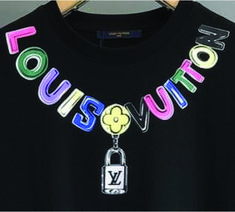 a black tshirt with the words louis vuitton on it and a lock