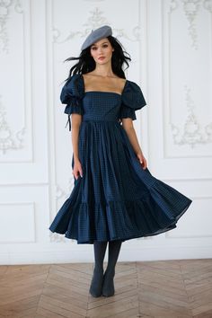 Capture the enchantment of rural France in this high-waist midi dress, boasting a pleated puff skirt and a playfully ruffled hem. Crafted with bows at the sleeve and waistline, and complete with pockets, it's the perfect attire for gathering fresh orchard apples and enjoying wine tasting in the countryside. Pair with the Farmhouse Tartan Duchess Corset to complete the look. Paper cotton midi dress with puff sleeves Double layer pleated puff skirt and ruffled hem Side seam pockets Bow tie detail Christmas Midi Dress, Witchy Wardrobe, Silk Charmeuse Dress, Rural France, Puff Skirt, Skirt Swimsuit, Market Dress, Puff Dress, York Dress