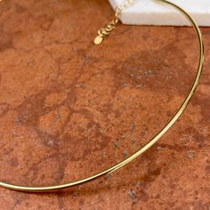 Polished-finish 18KT yellow gold round, stiff, tube wire collar necklace. Length: 18"+ Adjustable 19.5" Width: 2.5mm Weight: 17.18 grams Adjustable lobster clasp Fits on and holds in place Stamped 18k Made in Italy Minimalist Yellow Gold Tarnish Resistant Choker, Dainty Gold Hoop Necklace, Minimalist Gold Hoop Necklace, Gold Circular Necklace With Polished Finish, Gold Circle Necklace With Polished Finish, 14k Yellow Gold Choker, Modern Yellow Gold Choker As Gift, Modern Yellow Gold Choker For Gift, Dainty Gold Round Choker