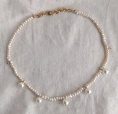 "This is a POP UP PEARL NECKLACE/CHOKER LISTING < - < - < - One of a kind pearl choker necklaces - > - > - > This princess inspired necklace/choker features a gorgeous fresh water Pearls, hand beaded -> 🎁 This Necklace is Perfect for gift giving 🎁 Can wear it layered with gold necklaces or by itself. D E T A I L S - Made with 3mm freshwater pearls. The round hanging pearl are Swarovski pearls size 4-5mm - Hand beaded on white silk thread. - Finished with - 18K Gold Plated Bridesmaid Pearl Necklace, Pearl Necklace Choker, Gold Link Necklace, Bridesmaid Pearls, Gold Coin Necklace, Gold Medallion, Princess Inspired, Inspired Necklace, Pearl Choker Necklace