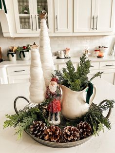 a christmas centerpiece with pine cones, greenery and a gnome figurine