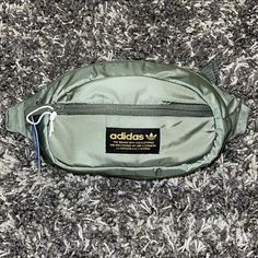 New Adidas Originals National Waist Pack / Crossbody Color: Major, Black, Gold ( Army, Military Green ) Size: Os *Unisex* *Ships Same Day Or Next!!!! *Please Feel Free To Ask Any Questions!!!! Product Details Fabric Type 100% Polyester Care Instructions Hand Wash Only Origin Imported Country Of Origin Indonesia About This Item Branding In Front. Zippered Main Compartment And Small Front Pocket. Key Fob In Front Pocket. Clip-Lock Closure. Metal Pullers. Description Worn Across Your Body Or Around Casual Streetwear Bags With Pockets, Casual Adidas Bag With Zipper Closure, Casual Adidas Bags With Zipper Closure, Casual Streetwear Bag With Zipper Closure, Green Zipper Closure Bag For Streetwear, Urban Green Bag With Pockets, Urban Green Nylon Bag, Everyday Adidas Nylon Bag, Functional Green Bags For Streetwear