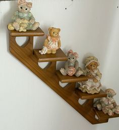 small teddy bears sitting on top of wooden shelves in the shape of a stair case