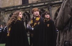 harry potter and hermione's hogwarts are standing in front of an old building