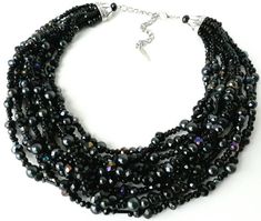 8 strands of black glass pearls are weaved together with sparkling aurora borealis black crystals and bugle beads in this stunning mid-century/vintage style piece.It's everything you need in a black statement necklace, with a pop of sparkling color to create the perfect elegant evening jewelry.Measurements: Approximately 17 inches with a 3 inch extender chain. Length can be adjusted upon request. Thank you for visiting my shop! Please feel free to message me with any questions, comments or custo Black Multi-strand Jewelry For Evening, Black Multi-strand Beaded Necklace For Evening, Multi-strand Black Beaded Necklace For Evening, Glamorous Black Beaded Jewelry, Multi-strand Beaded Necklaces For Evening, Multi-strand Beaded Necklace For Evening, Beaded Multi-strand Necklace For Evening, Evening Black Beaded Necklaces, Costume Jewelry Beaded Necklace With Round Beads For Evening