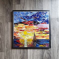 a painting hanging on the side of a wall next to a wooden floor with a sailboat painted on it